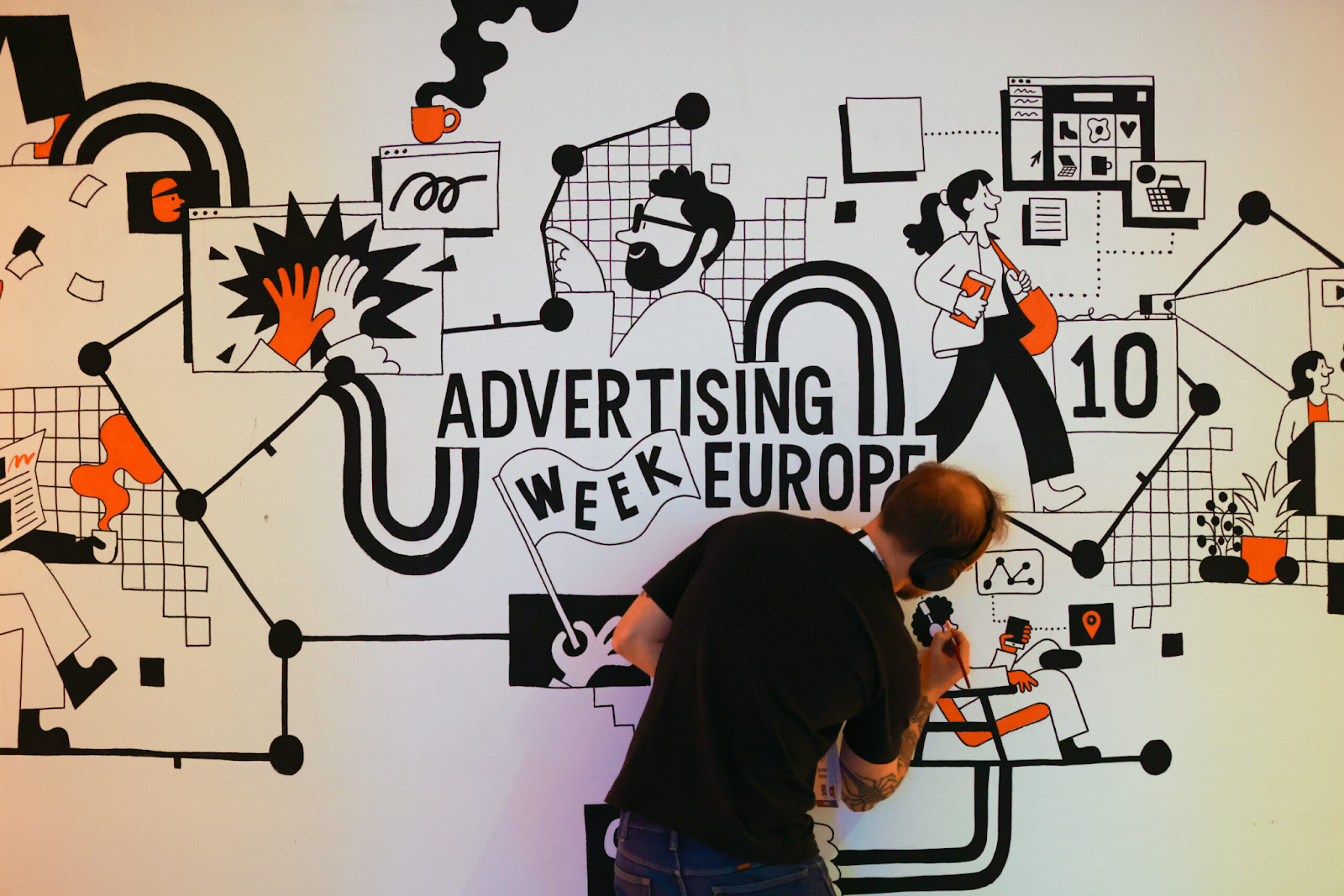 An artist illustrating an advertisement for Advertising Week Europe.